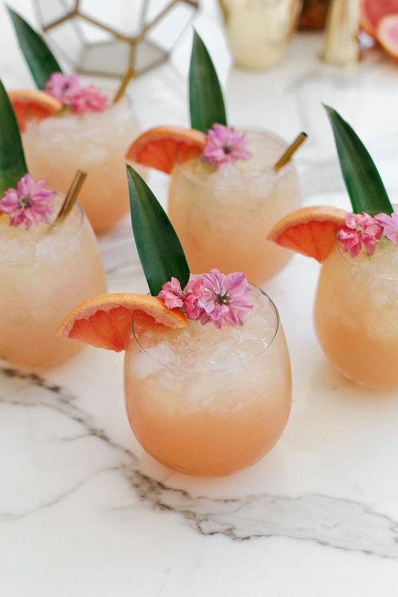 Five summer cocktails in glasses on a mosaike table.